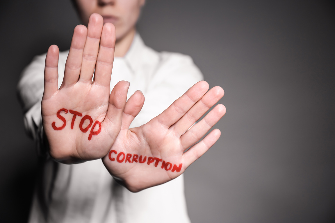 Woman with Text STOP CORRUPTION Written on Her Palms against Grey Background, Closeup